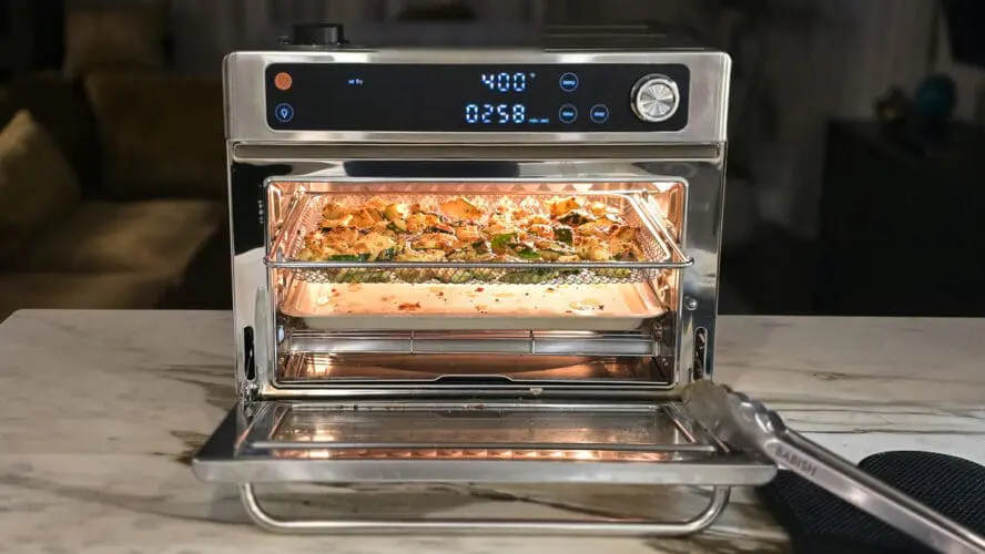 Image of the Our Place Wonder Oven Pro in stainless steel being used to roast zucchini, with its digital display showcasing the oven on 400 degrees Fahrenheit.