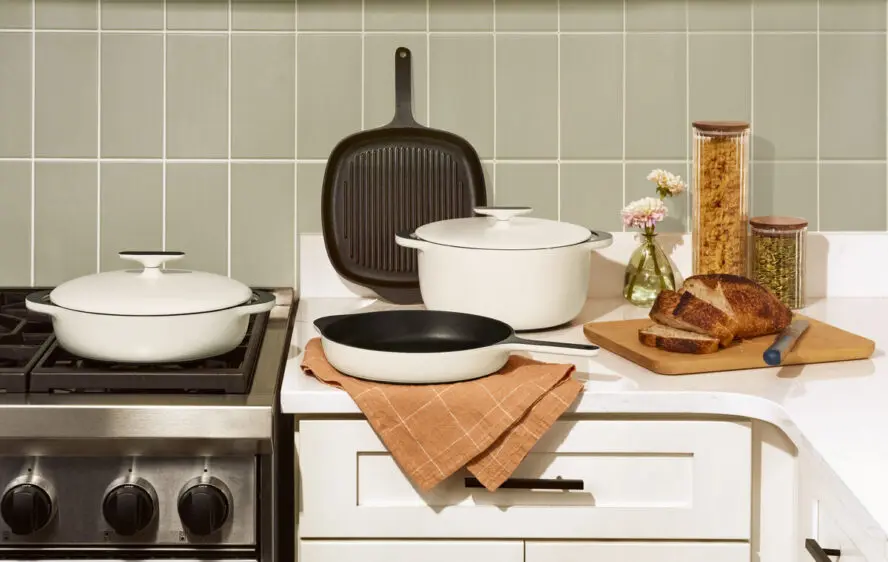 Image of several pieces in the Caraway Cookware enameled cast iron collection, including the Dutch oven.