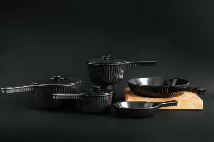 Image of several pieces in the Xtrema Cookware Founder's Classic Collection displayed against a black background.
