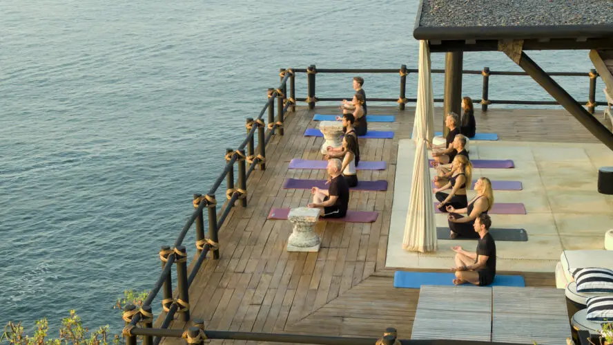 Image of a group yoga session overlooking the water.