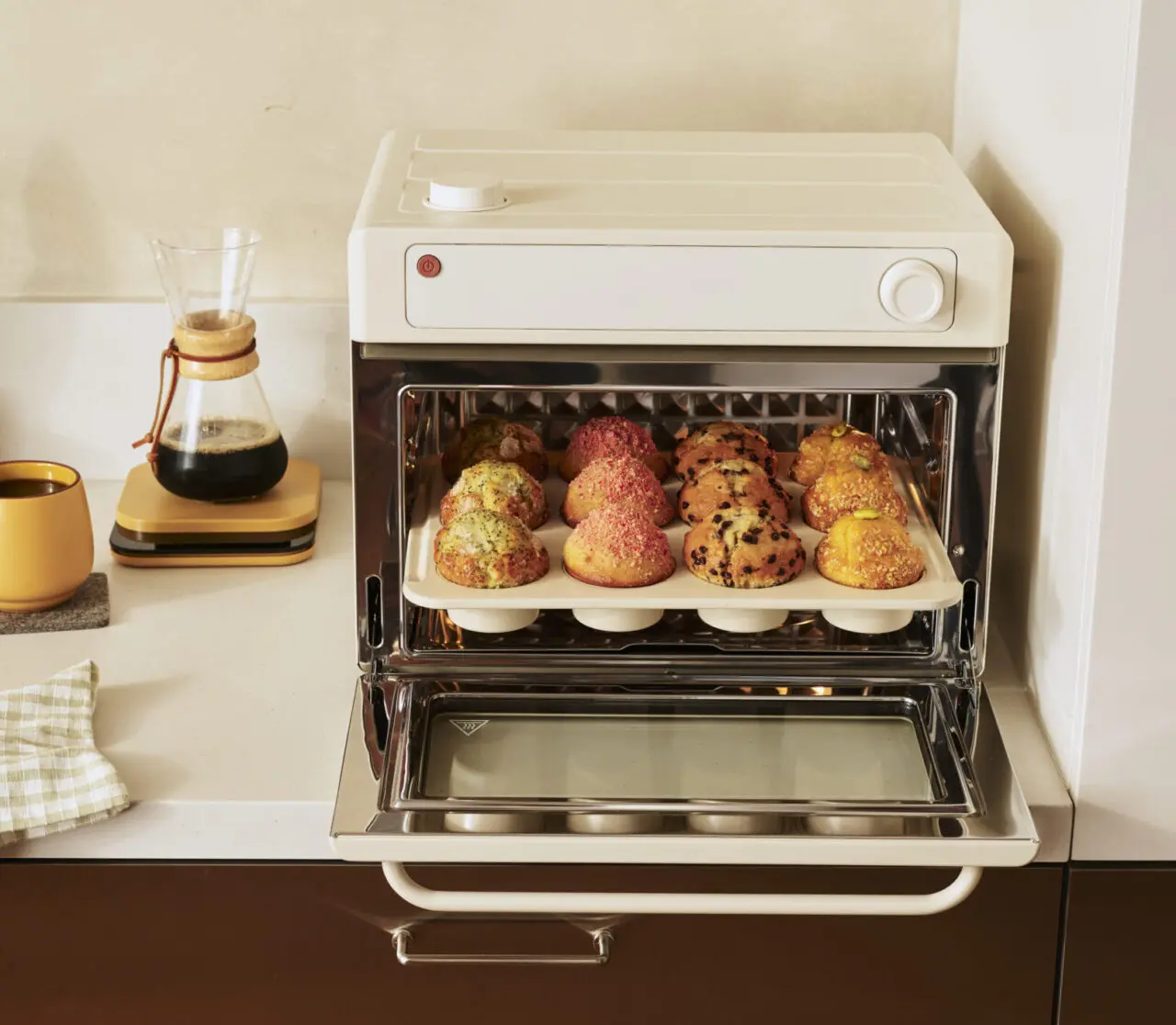 Image of the Our Place Wonder Oven Pro in the color Cream, being used to dehydrate colorful citrus fruit slices.