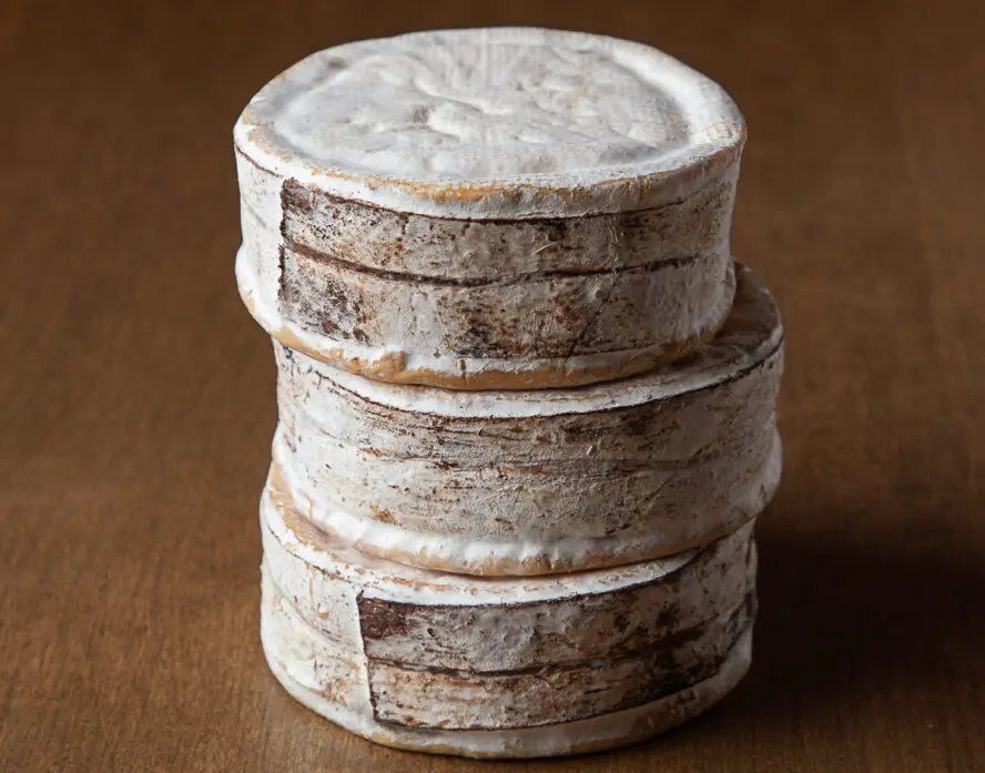 Image of a stack of Rush Creek Reserve cheese rounds from Uplands Cheese.