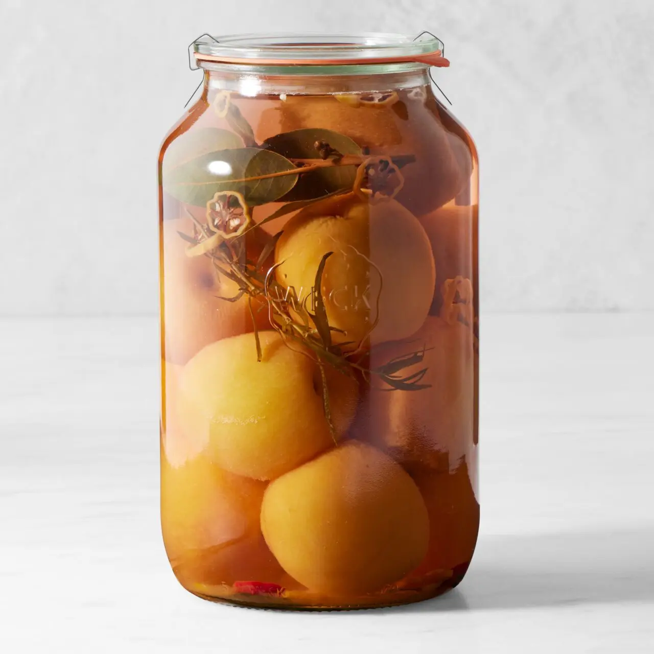 Image of the Weck Barrel Jar from Williams Sonoma filled with pickled fruits.