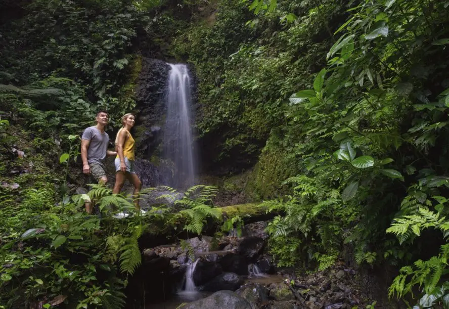 Image of a couple climbing at the private waterfall at Origin Floral Luxury Lodge.