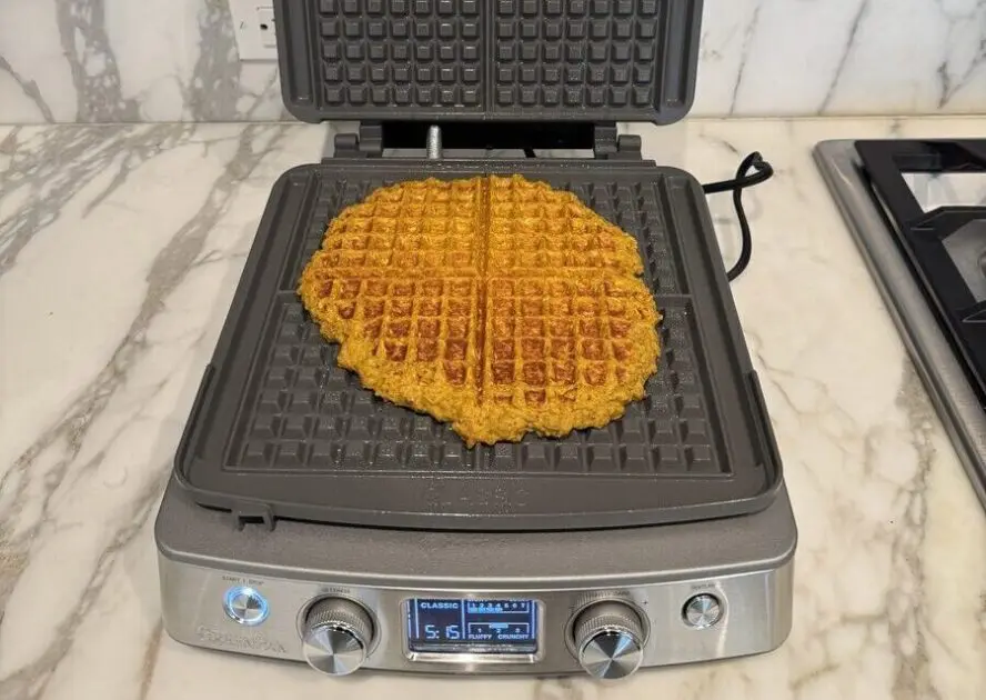 Image of the GreenPan Elite Ceramic Nonstick 4-Square Waffle Maker shown with one giant waffle created across the waffle plate.