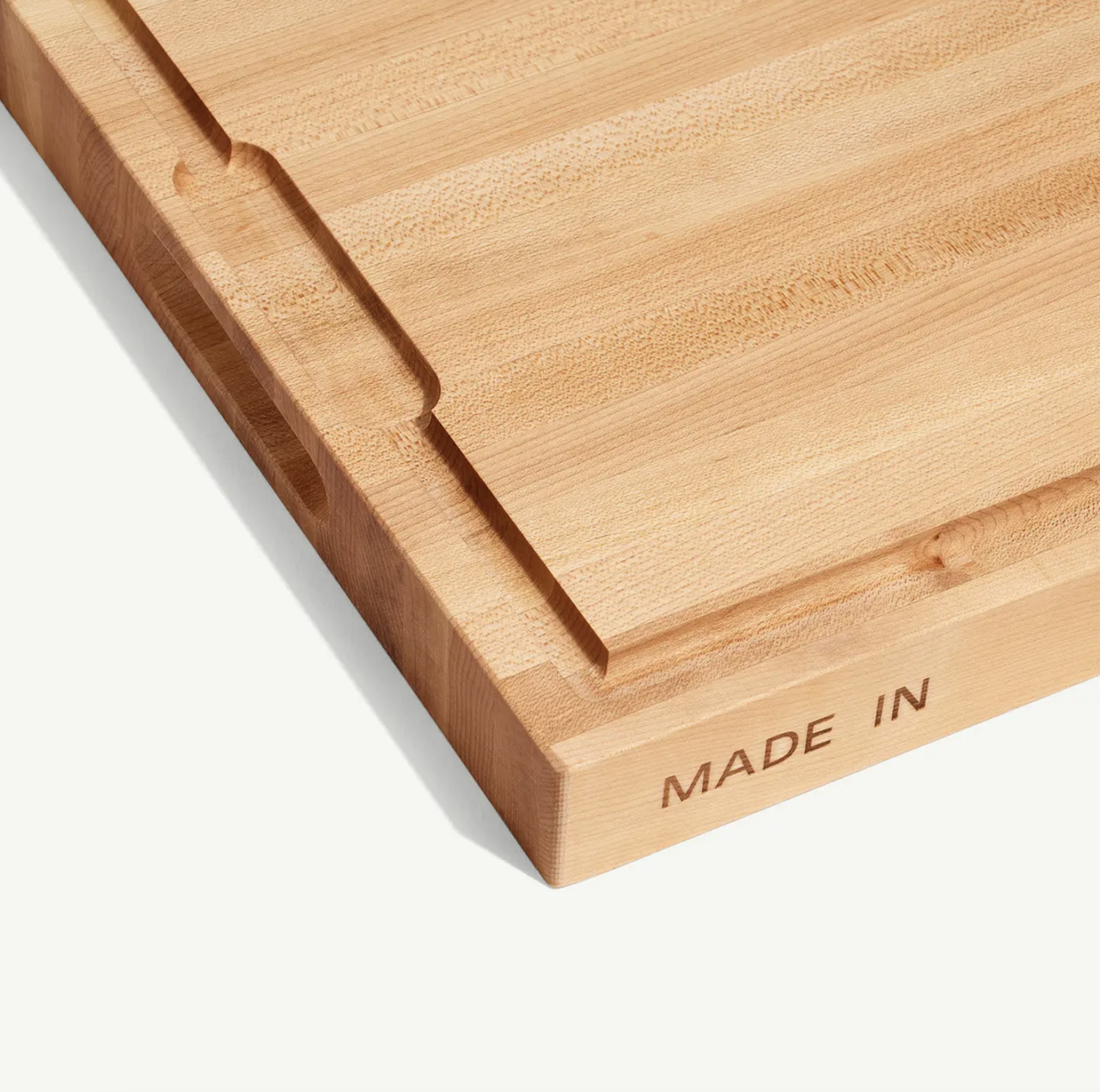 Image of a Made In Butcher Block, showcasing its finger groove to catch juices from food prep.