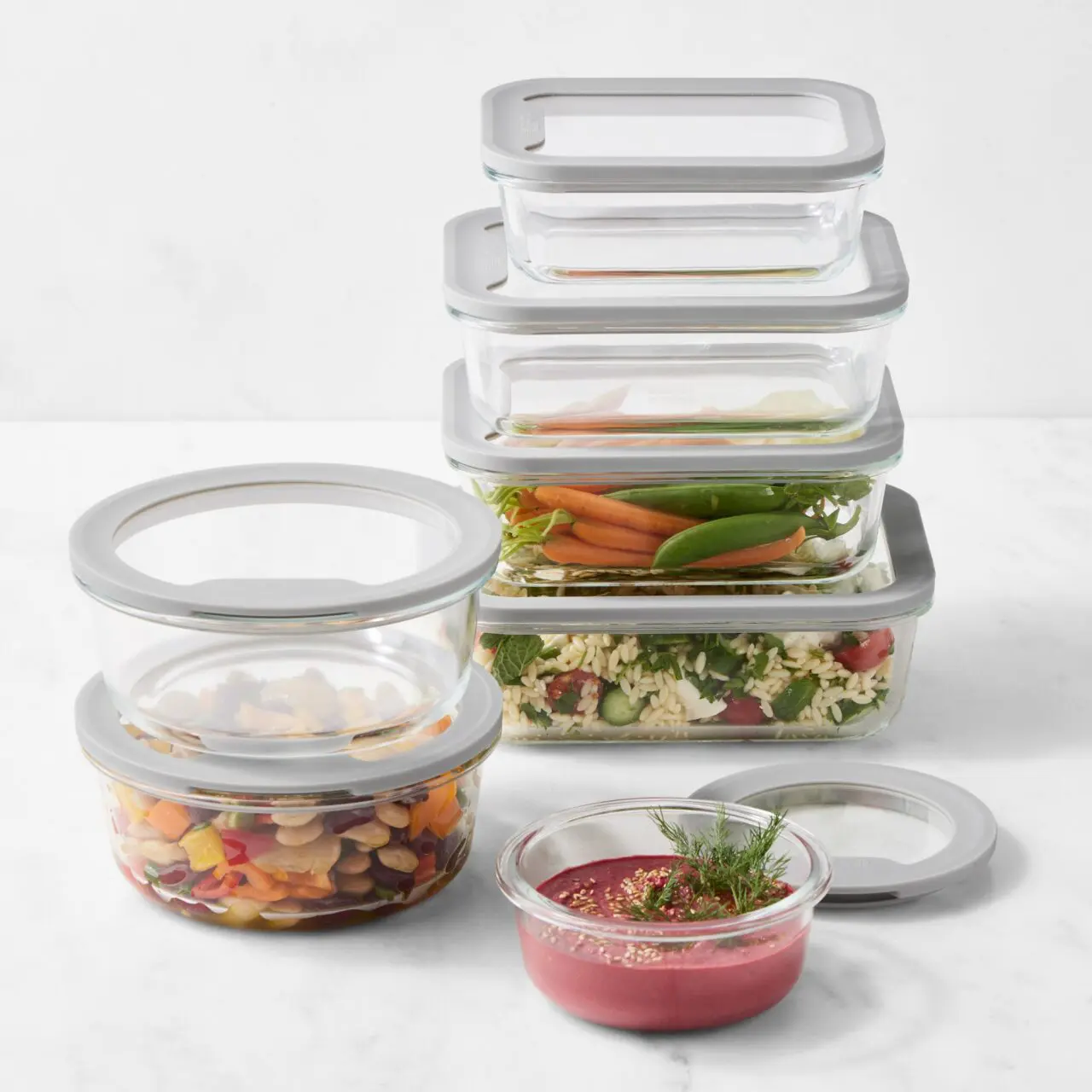 Image of two stacks of Williams Sonoma Hold Everything glass containers, some empty and some holding leftovers.