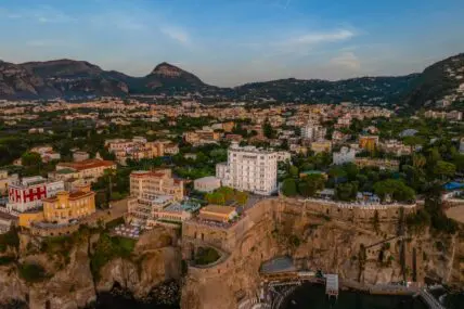 Drone image of Hotel Mediterraneo Sorrento on the cliffs overlooking the sea.