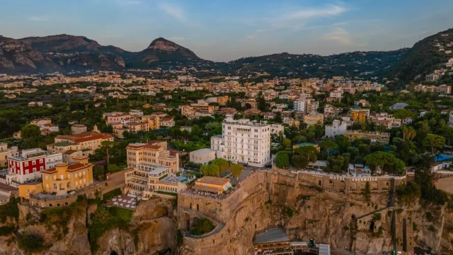 Drone image of Hotel Mediterraneo Sorrento on the cliffs overlooking the sea.