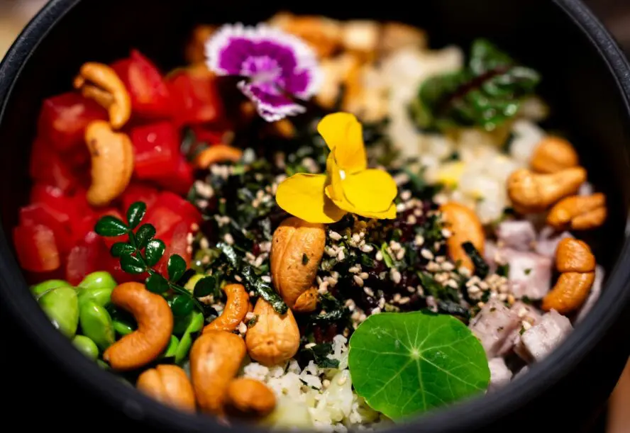 Close-up image of a healthy rice bowl, including brain-boosting nuts like cashews and sesame.