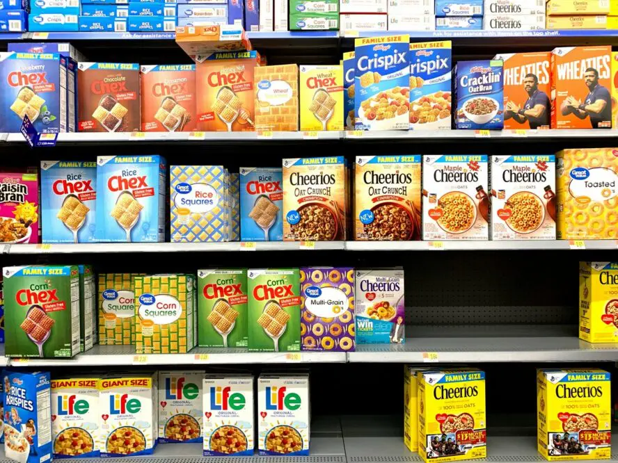 Image of shelves in a cereal aisle at a supermarket showcasing a wide range of different types of cereal options.