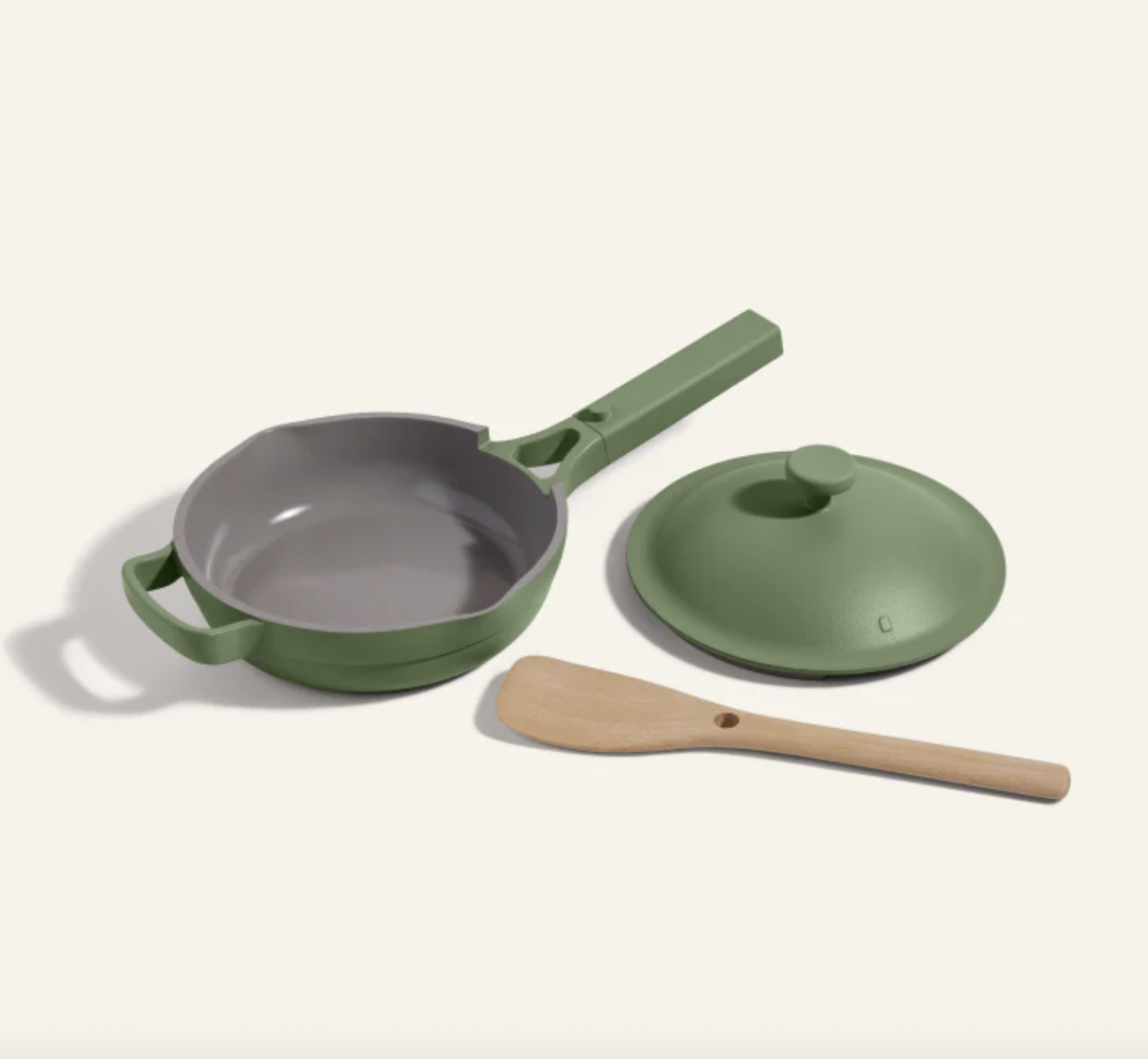 Image of the Our Place Mini Always Pan in a trendy green color, with the beechwood spatula and lid shown separately.