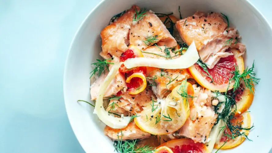 Image of a bowl filled with salmon, dill, fennel, grapefruit, and more.