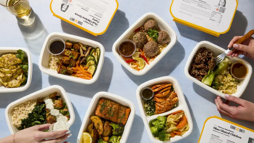 Image of a spread of meal delivery trays from CookUnity with various colorful meals.