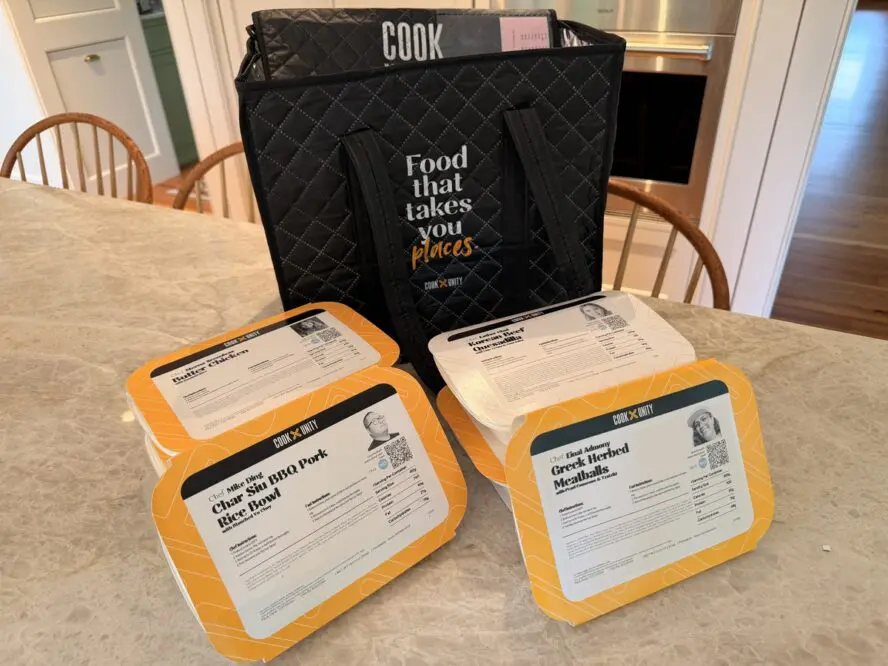 Image of several meal deliveries from CookUnity, shown in front of the delivery bag that keeps everything nice and cold.
