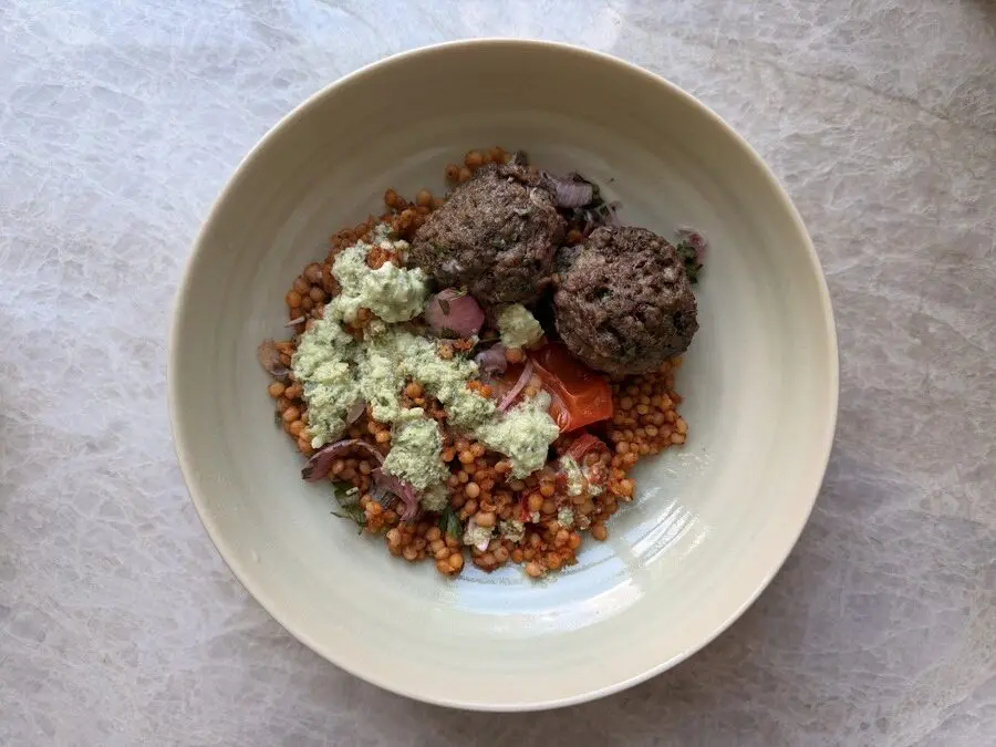 Image of a plate of Greek herbed meatballs from a CookUnity meal delivery.