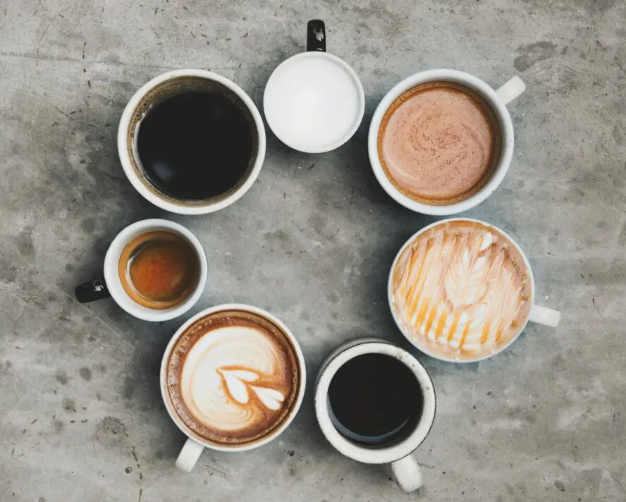 Image of several mugs of different types of coffee shown in a circle.