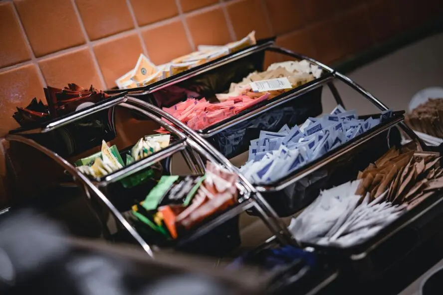 Image of a set-up at a diner showcasing various sweetener packets.