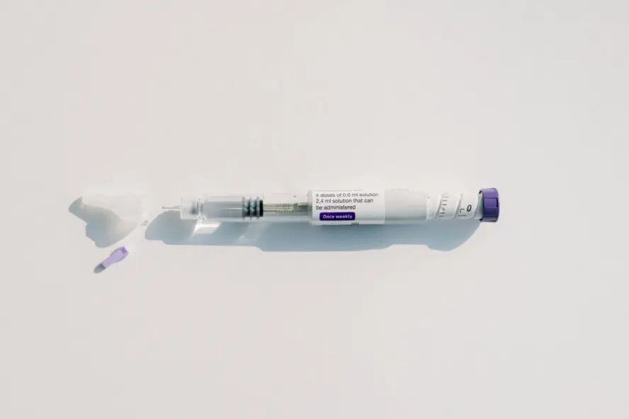 GLP-1 injector for weight loss on blank white surface