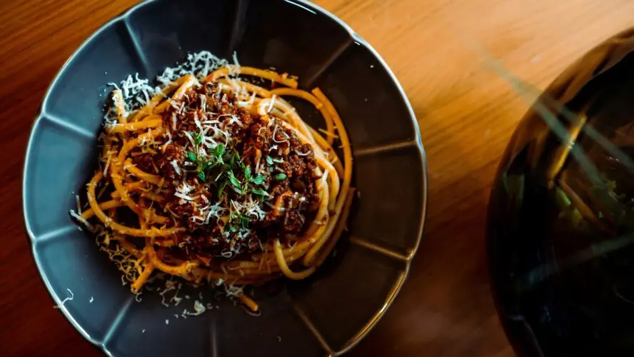 Image of a plate of pasta with homemade Bolognese sauce with ground beef.