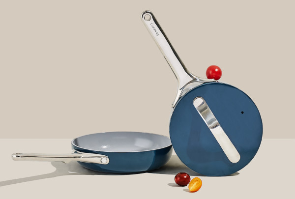 Image of Caraway cookware minis duo with tomato on white counter with beige plain backsplash via Organic Authority