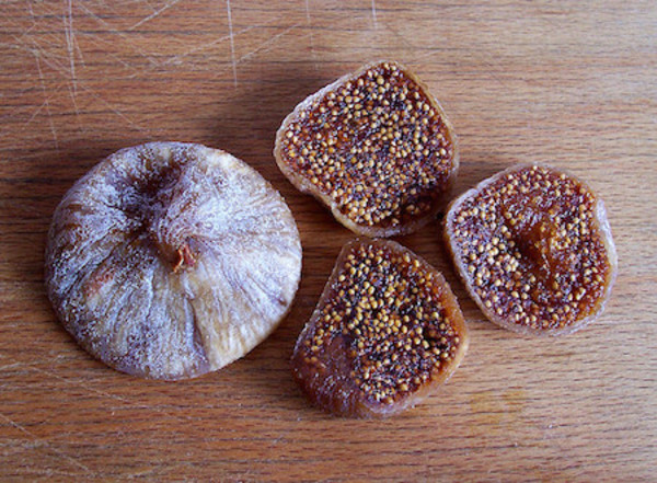 Baked goods with seeds and sugar coating on wooden surface