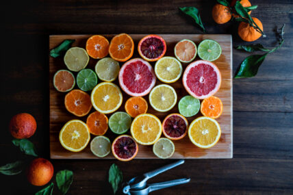 cut citrus, oranges, grapefruit, lime, lemons on cutting board