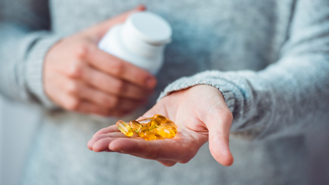 hand holding dietary supplements