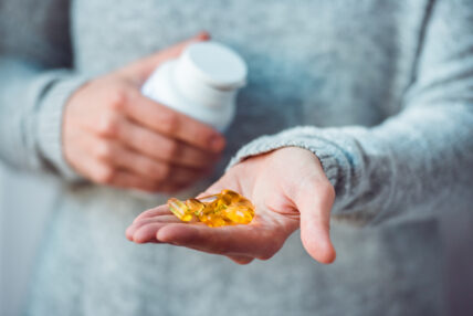 hand holding dietary supplements