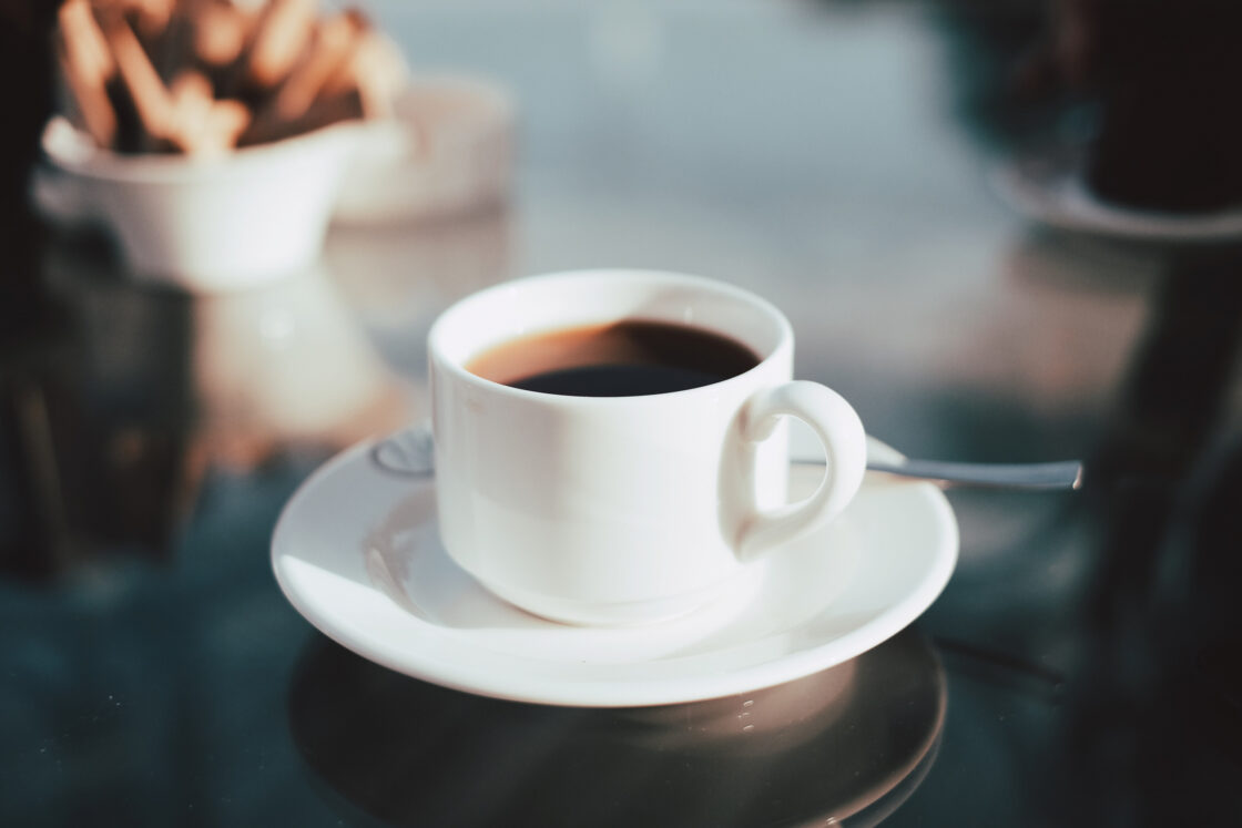 Thyroid hormones affect women. It's important to balance the different types of hormones including estrogen, testosterone and more - Cup of coffee on a table.