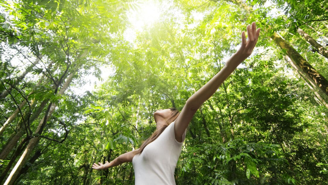 woman standing in forest, forest bathing