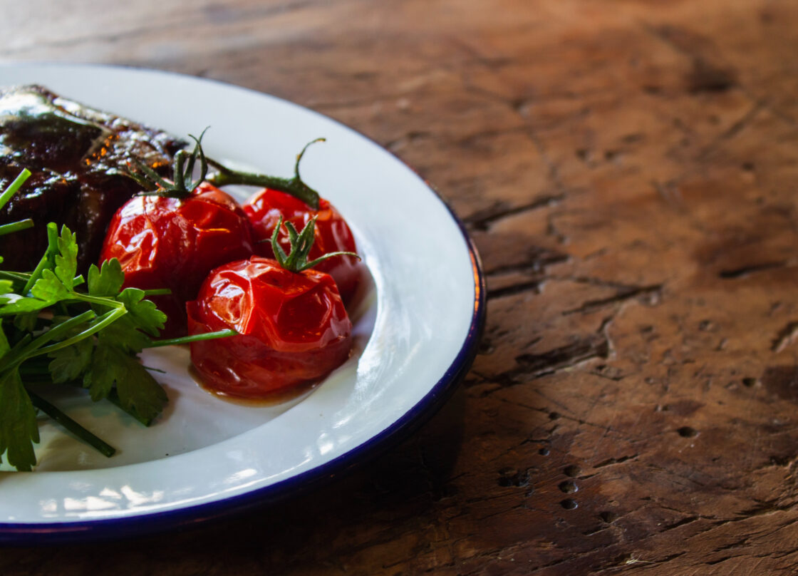 grilling vegetables on a white plate, how to grill vegetables via Organic Authority