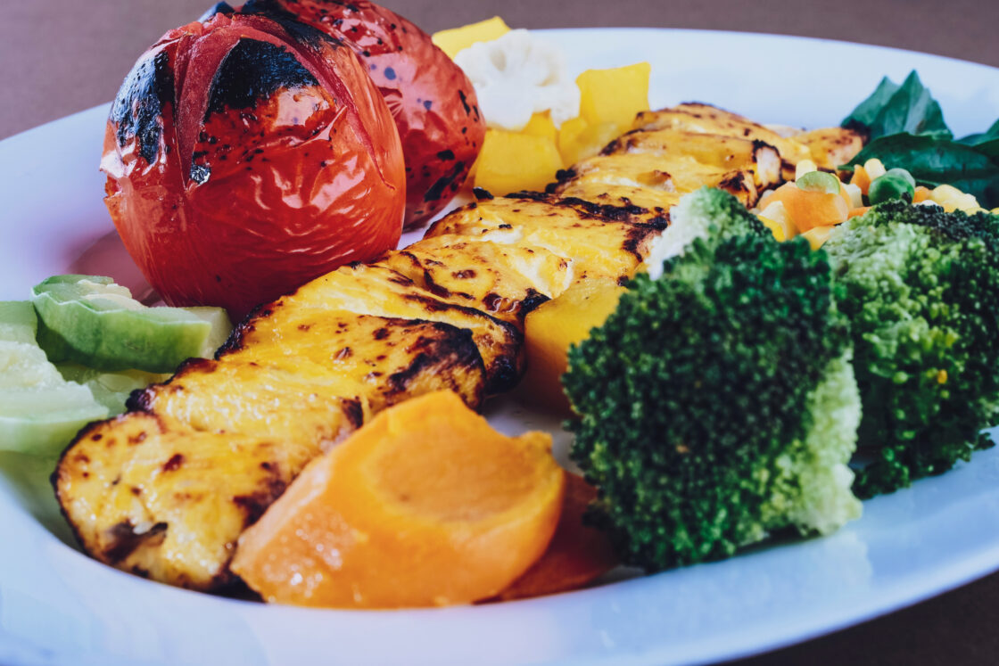 Grilled vegetables on white plate, how to grill vegetables via Organic Authority