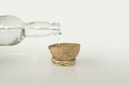 Image of a bottle pouring mezcal to represent what is mezcal. Here's Why Wellness Warriors are Sipping on Mescal
