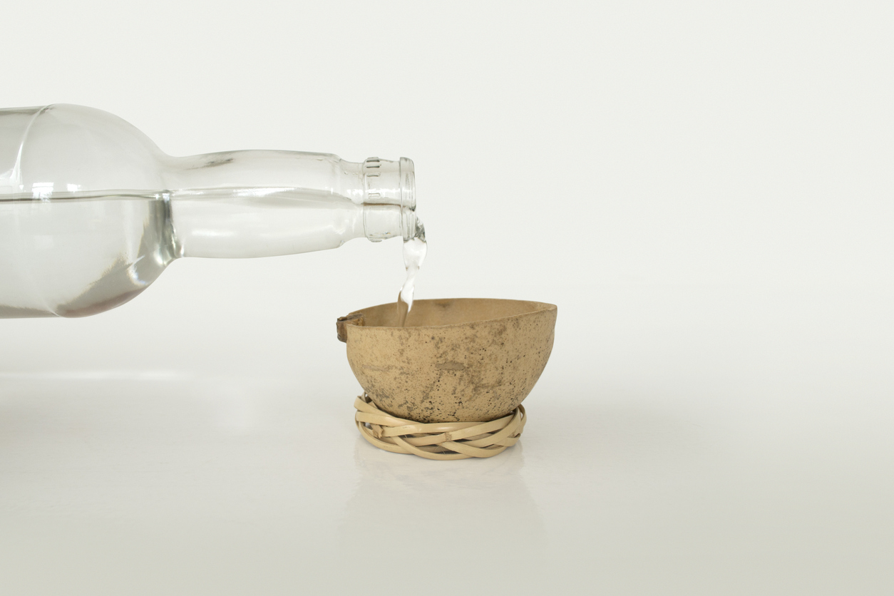 Image of a bottle pouring mezcal to represent what is mezcal. Here's Why Wellness Warriors are Sipping on Mescal