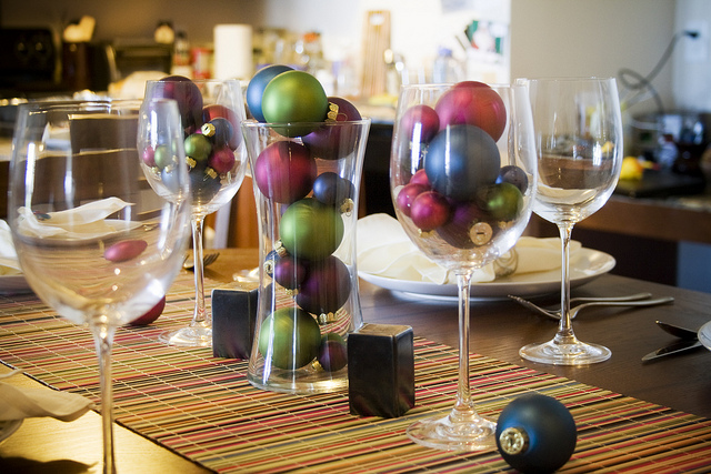 holiday ornaments and wine glasses holiday centerpiece photo