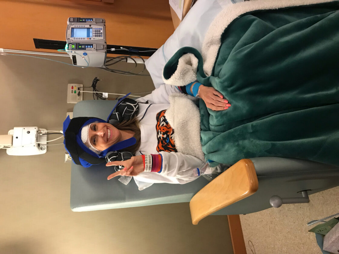 How a workout routine led to one woman's breast cancer. Virgina sitting in a chair receiving treatment.