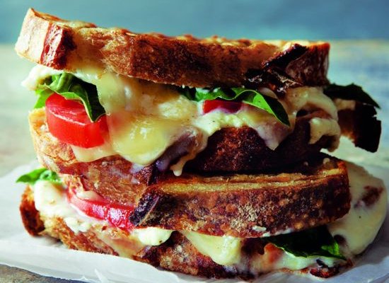 three cheese panini with tomatoes, basil and garlic spread