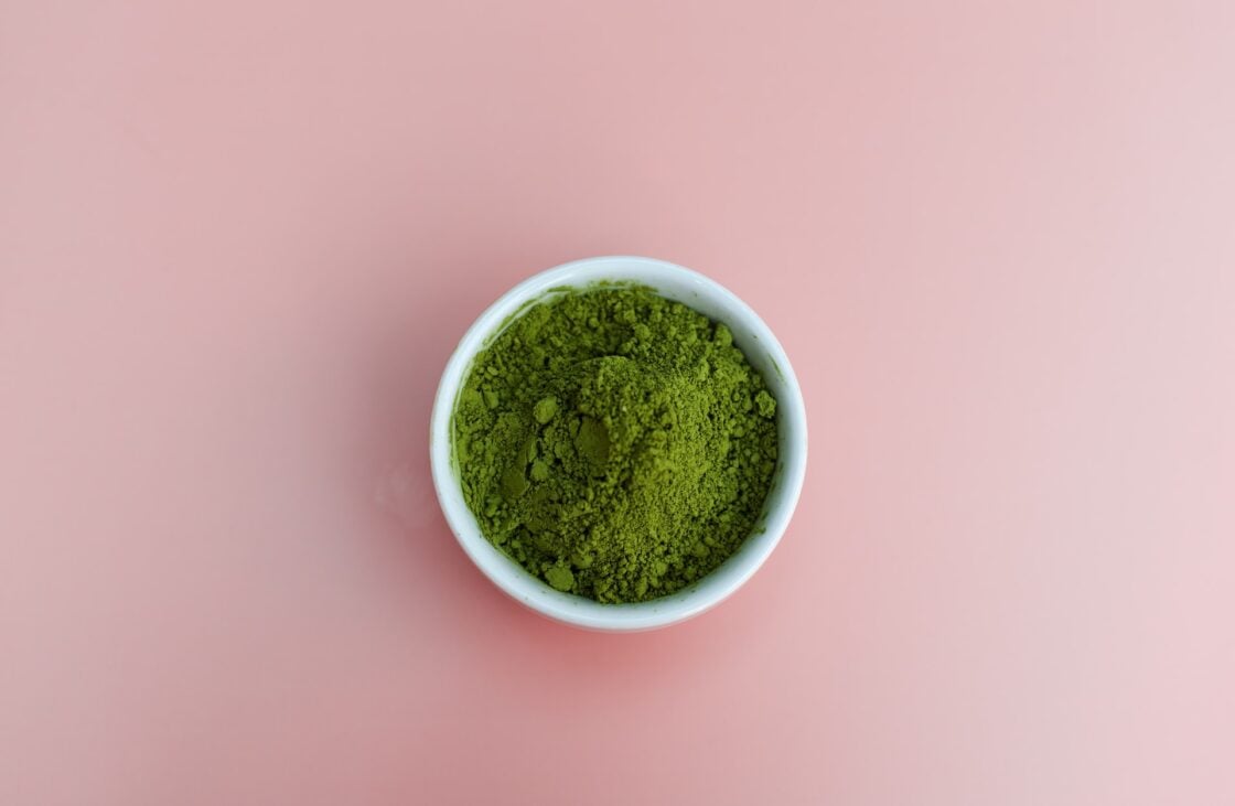 Image of organic super greens powder in white bowl on pink background. Finding your best greens powder can be a challenge! Many greens powders may contain questionable ingredients. There are many types of greens blend on the market. Green powders may support digestive health and gut health. Read on to discover the top greens powders.