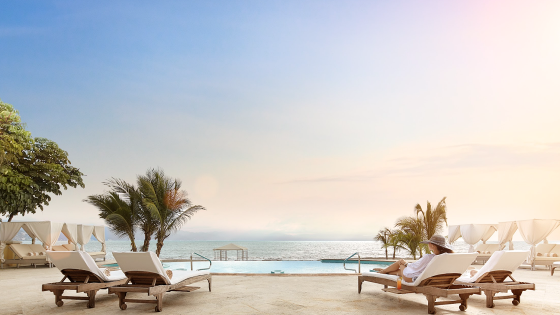 Beach club with a pool and a view of the ocean