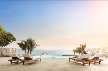 Beach club with a pool and a view of the ocean