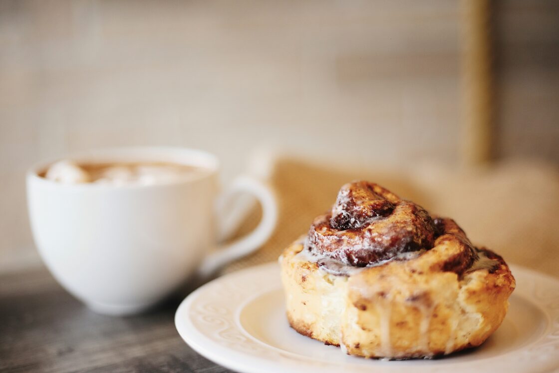 image of a vegan cinnamon roll recipe healthy with glaze and coffee
