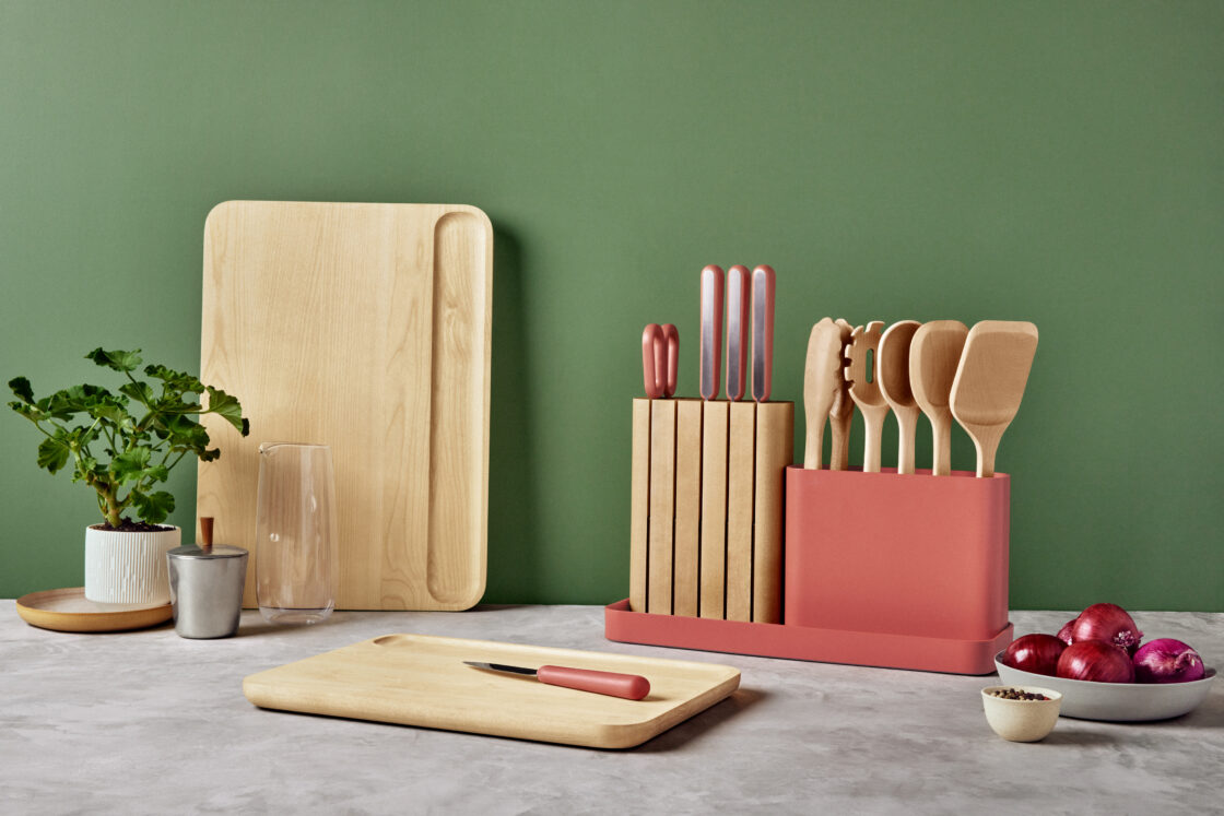 caraway prep set and cutting boards on countertop against green wall. 
