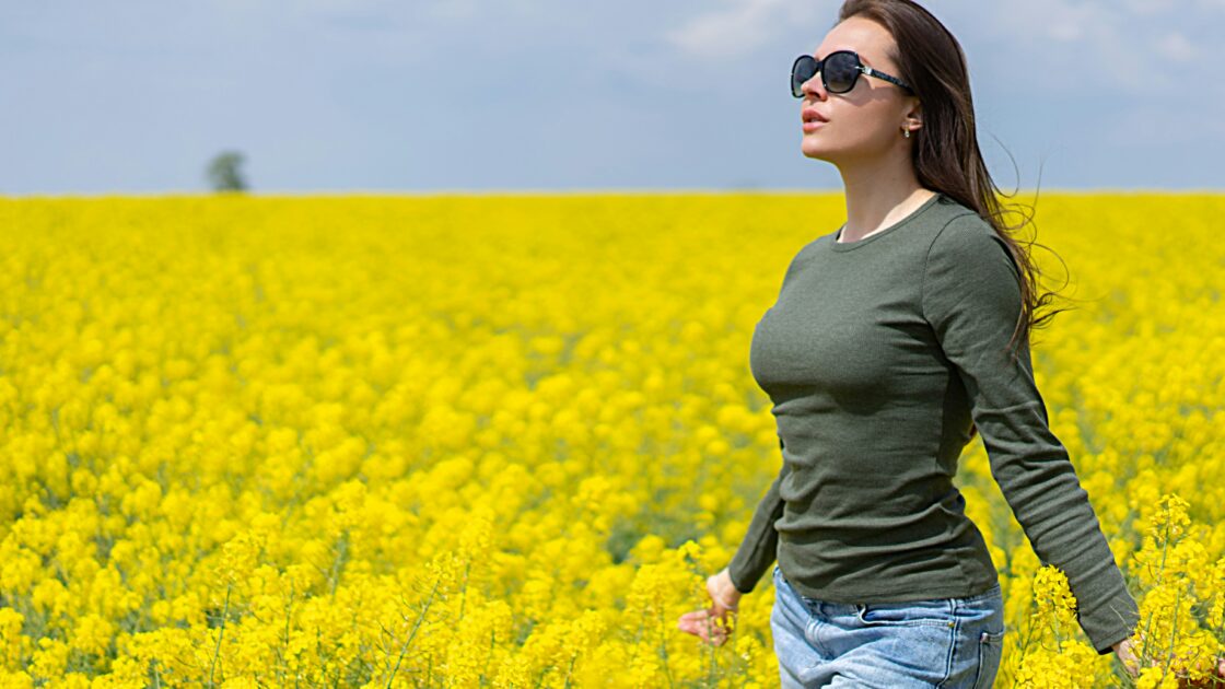 woman in field of yellow flowers for natural menopause remedies