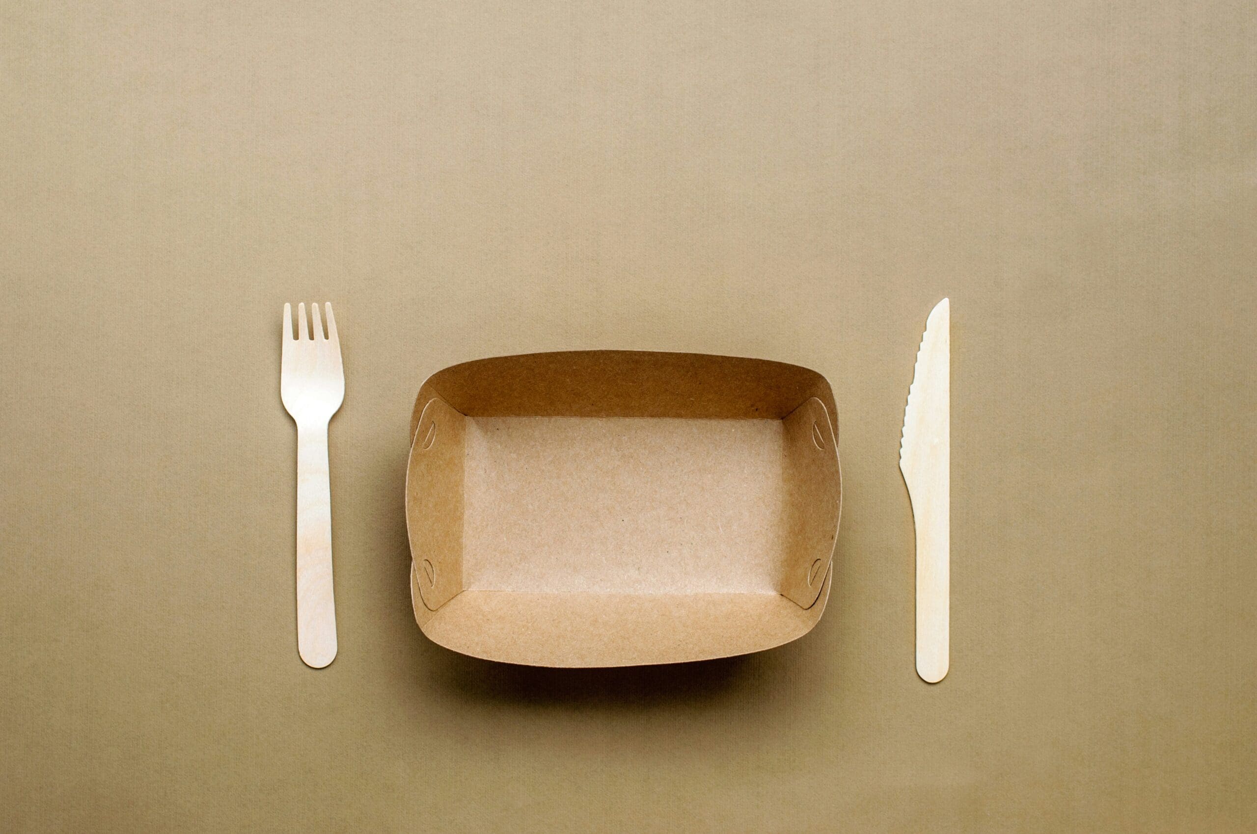 image of empty food container with fork and knife as experts say that you should not starve yourself if you