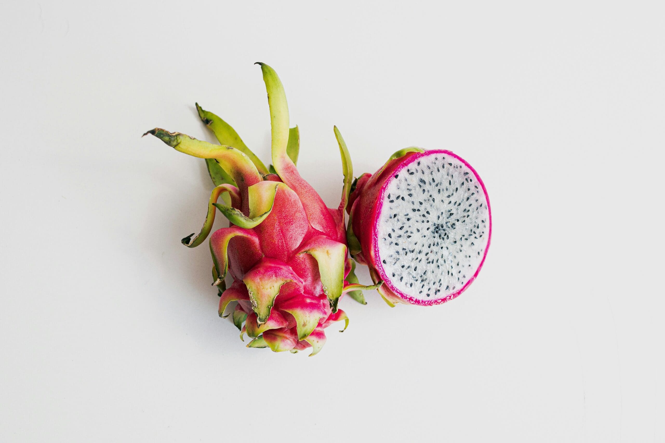 Image of a dragon fruit cut open showing the inside and the striking outside unusual fruits and vegetables