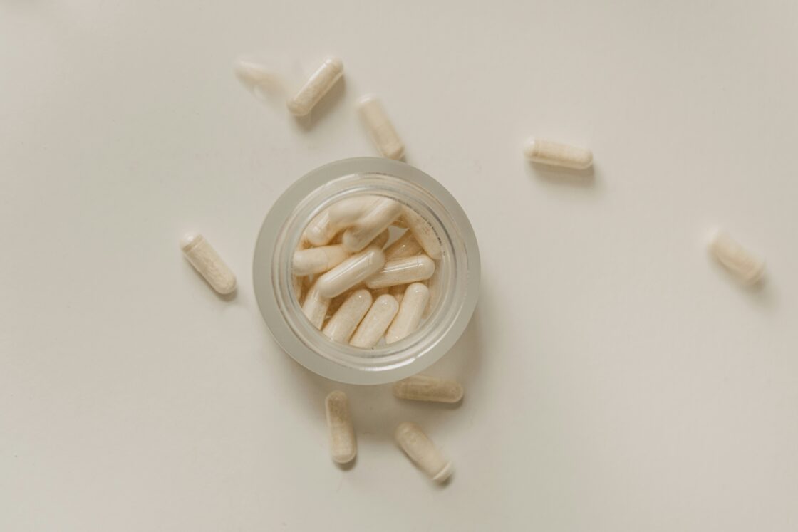 Image of an overhead view of a glass jar of supplements, natural heartburn relief