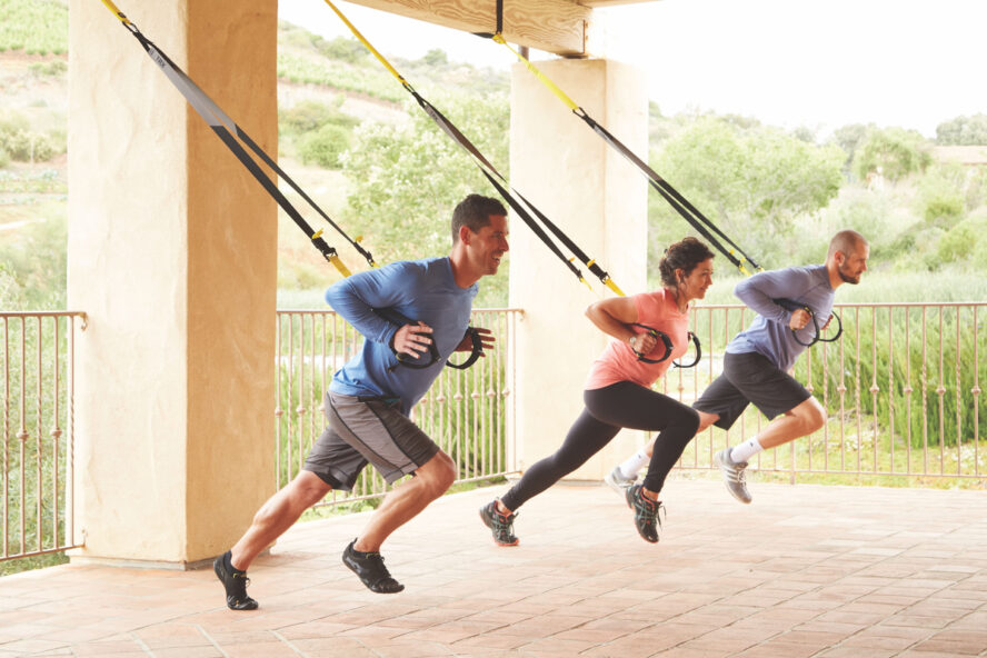 Image of three guests working out in a TRX fitness class at the Cal-a-Vie Health Spa, California.