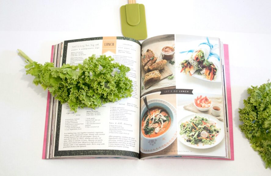 Image of an open cookbook propped open on some lunch recipes, a key benefit in my Nourish review.