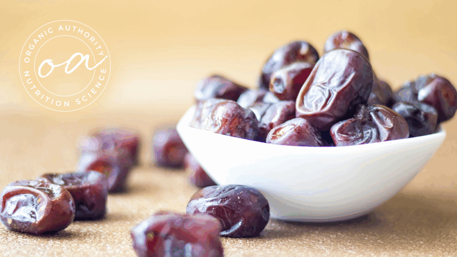 Image of a small white bowl of dates overflowing with dates.
